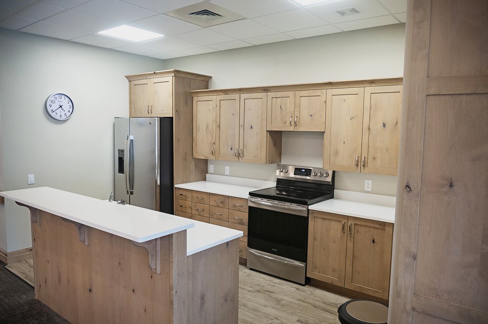 A modern kitchen with wooden cabinets and stainless steel appliances.