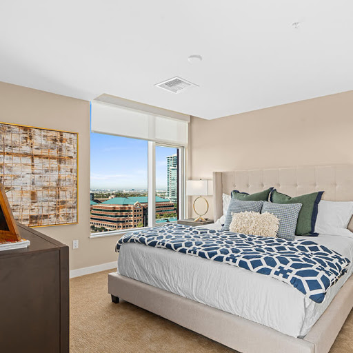 A stylish and cozy bedroom featuring modern decor and a beautiful window view.