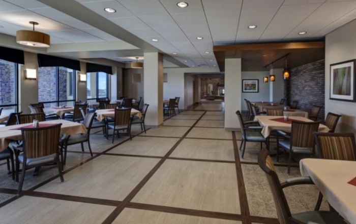 A spacious and elegantly designed restaurant dining area with neatly arranged tables and chairs.