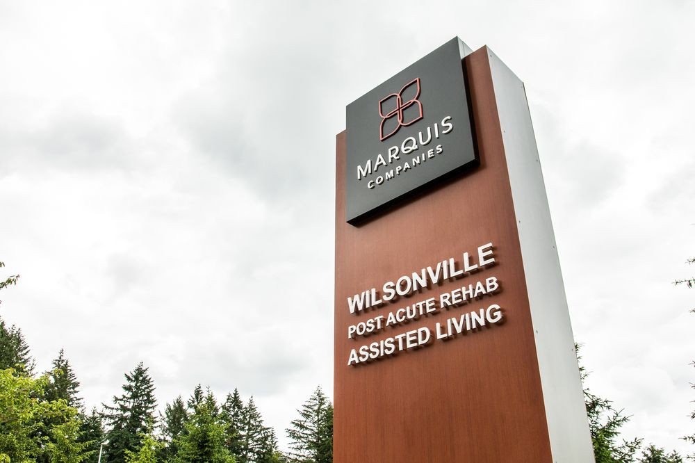 A tall sign for Marquis Wilsonville Post Acute Rehab and Assisted Living.