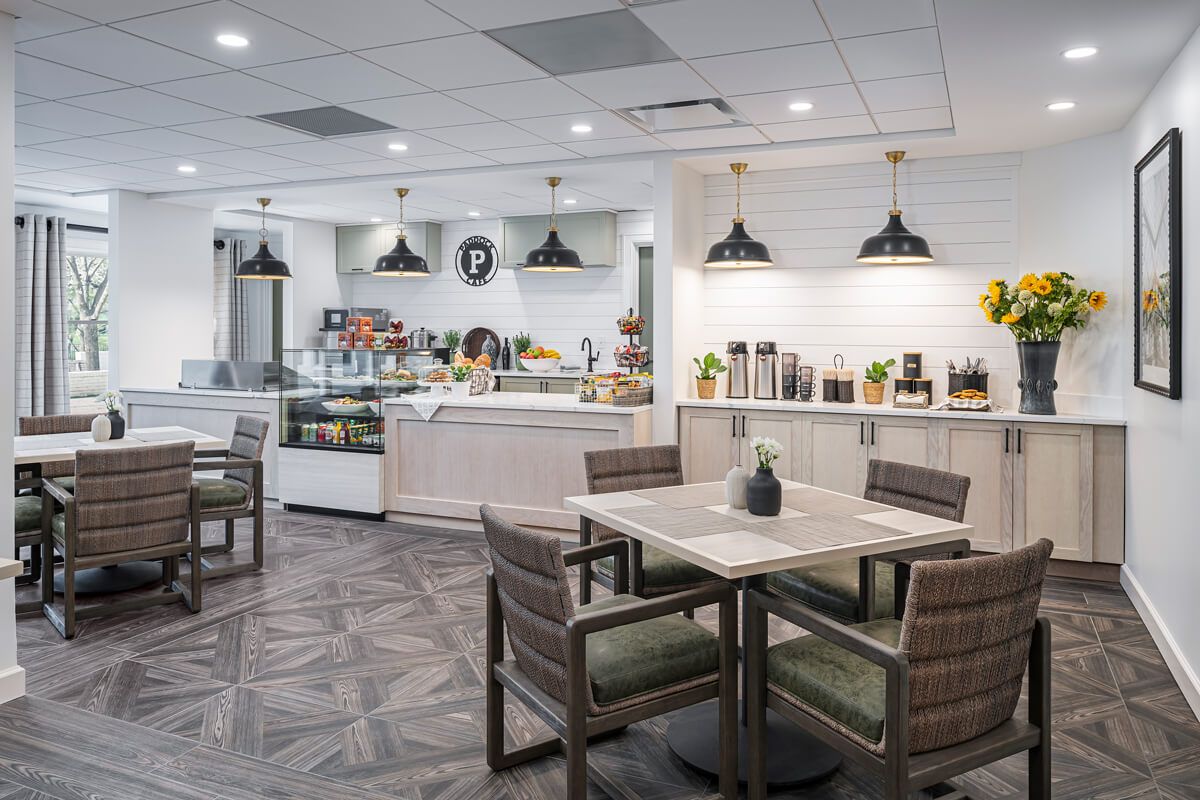 A modern cafe interior with a coffee station and comfortable seating.