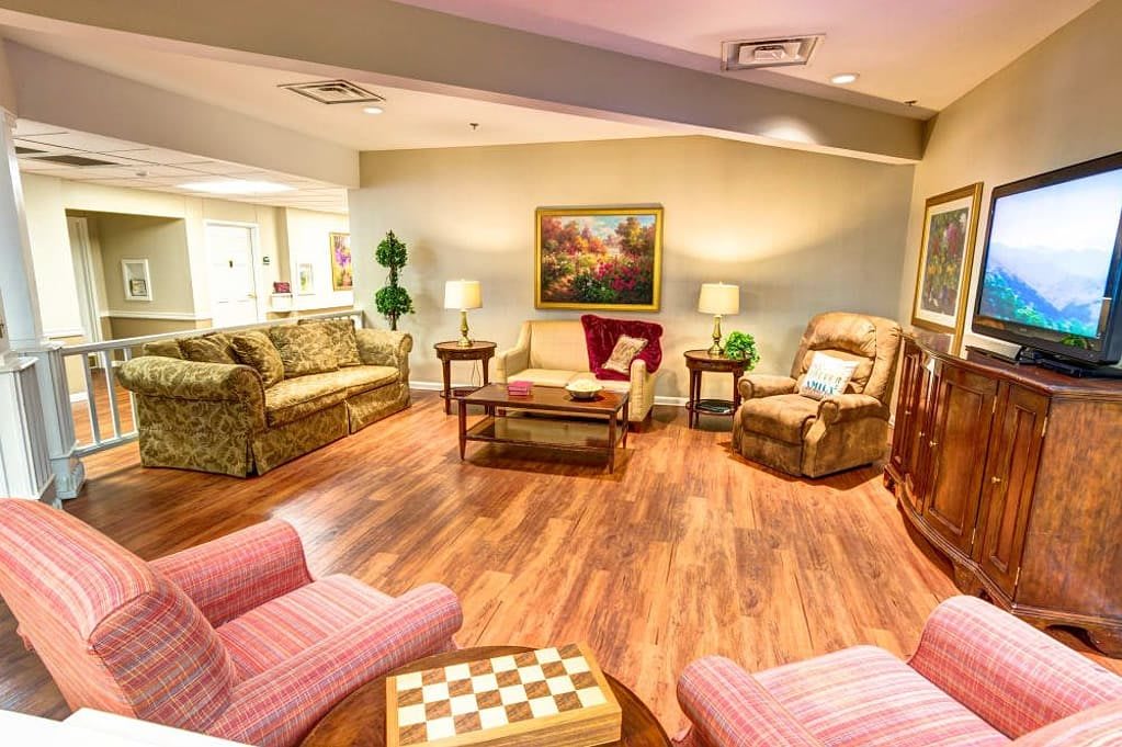 A cozy living room with comfortable seating and warm lighting.