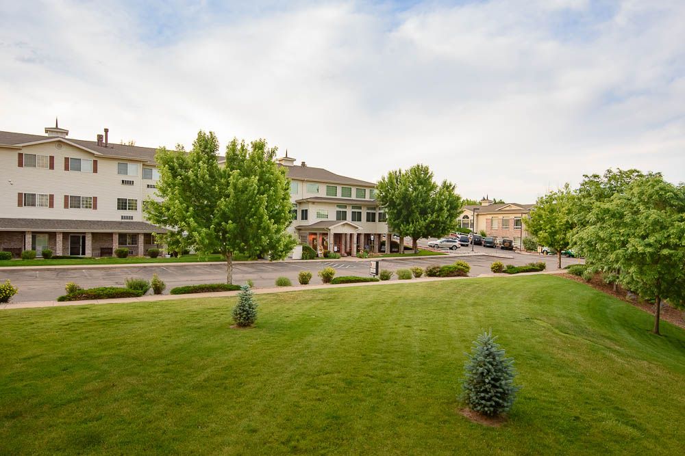 A peaceful suburban neighborhood with neatly maintained lawns and trees.