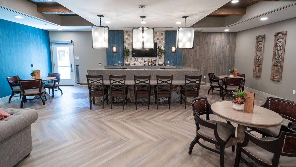 A modern bar area with seating and stylish lighting.