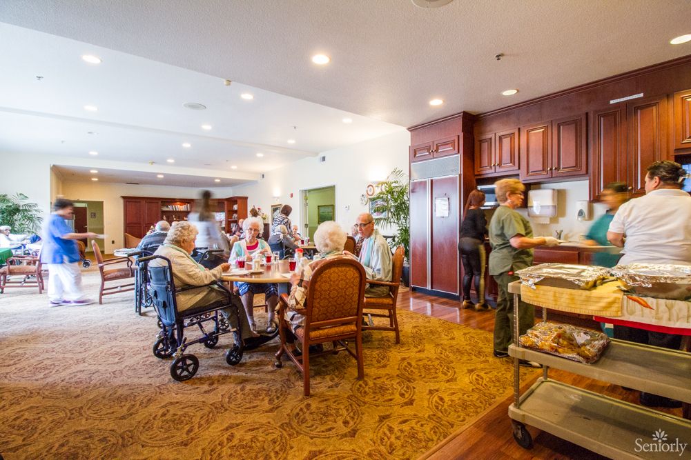 Seniors enjoying a meal together in a community dining area.