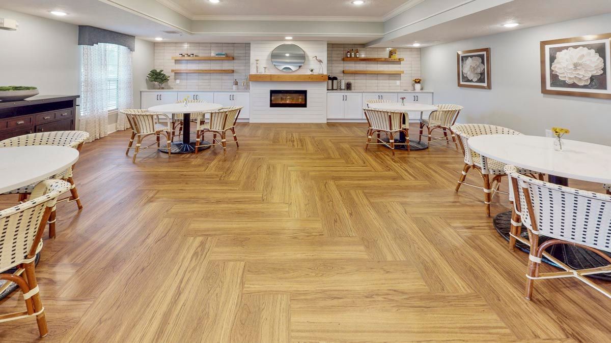 Spacious dining area with elegant wood flooring and modern decor.