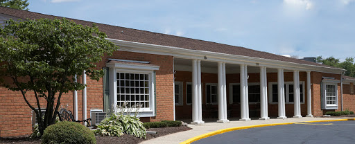 A well-constructed building featuring brick walls and elegant columns.