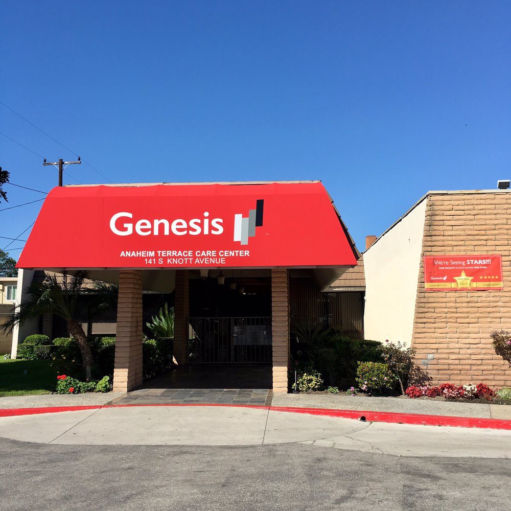 Entrance of a building with a red awning labeled 'Genesis'.