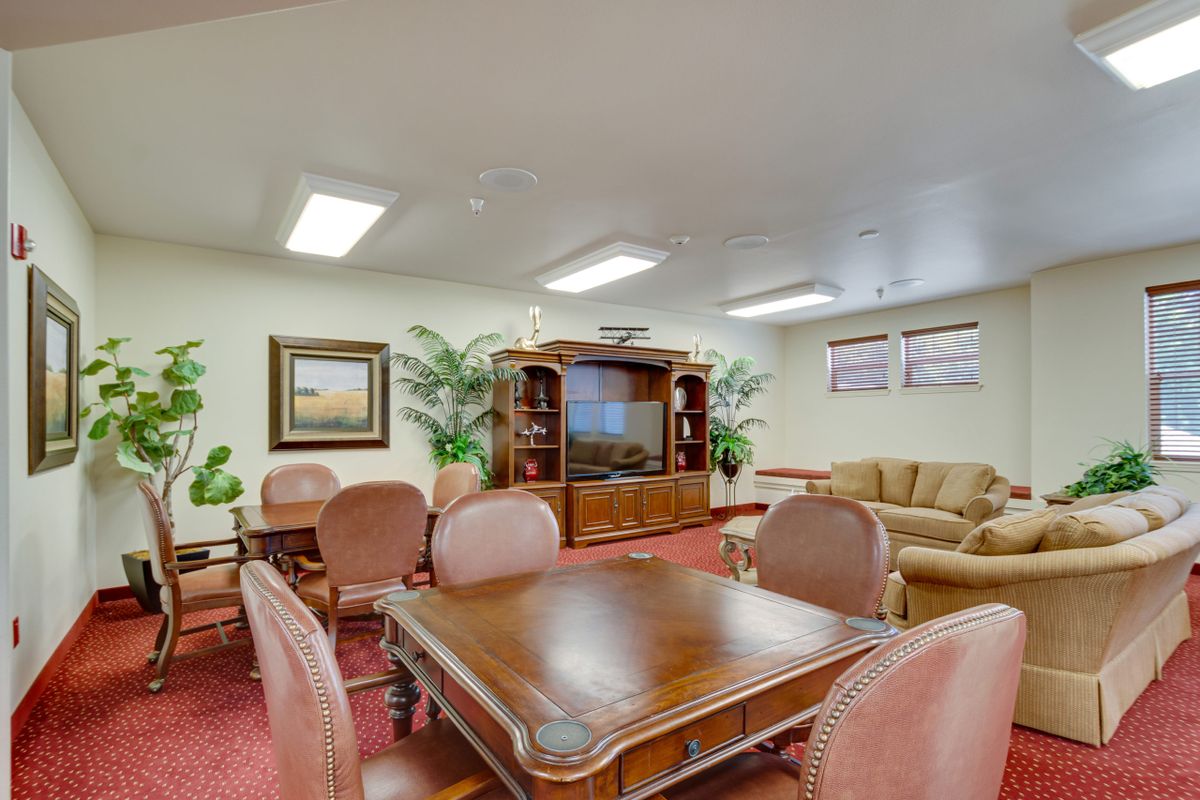 A cozy living room with comfortable seating and a large television.