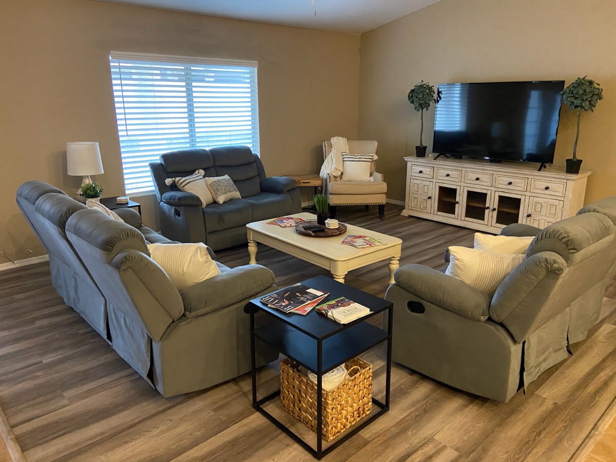 A cozy living room with sofas, a coffee table, and a TV.