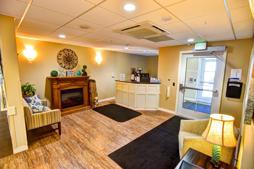 A cozy reception area with comfortable seating and a fireplace.