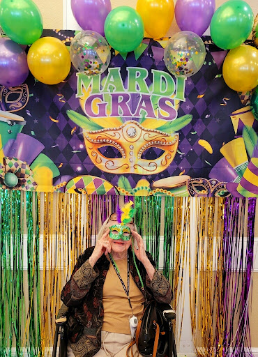 A festive Mardi Gras celebration with vibrant decorations and a playful mask.