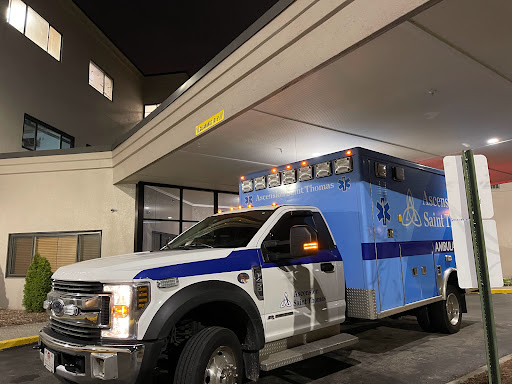 An emergency ambulance parked at night, ready for urgent medical transport.