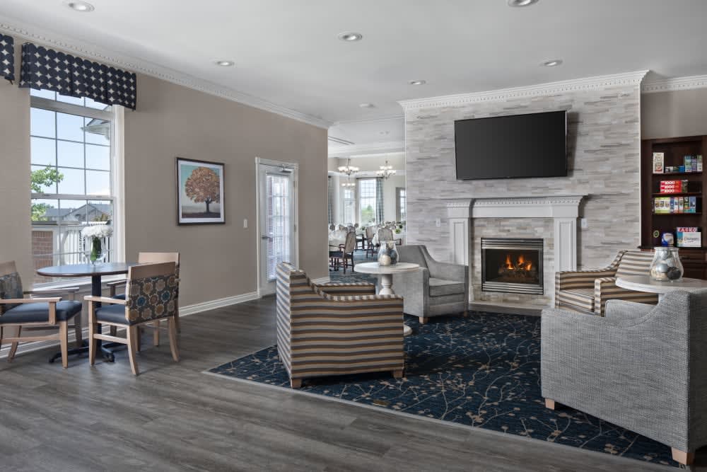A modern living room featuring sleek furniture and a cozy fireplace.