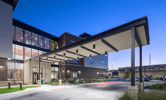 A modern healthcare facility illuminated at night.