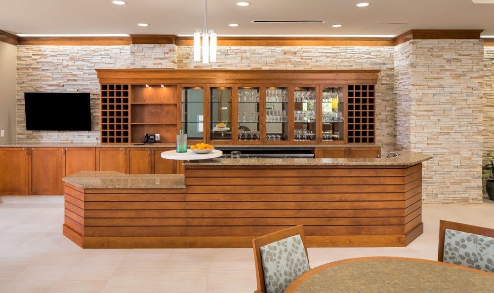 A modern bar area with wood finishes and elegant lighting.