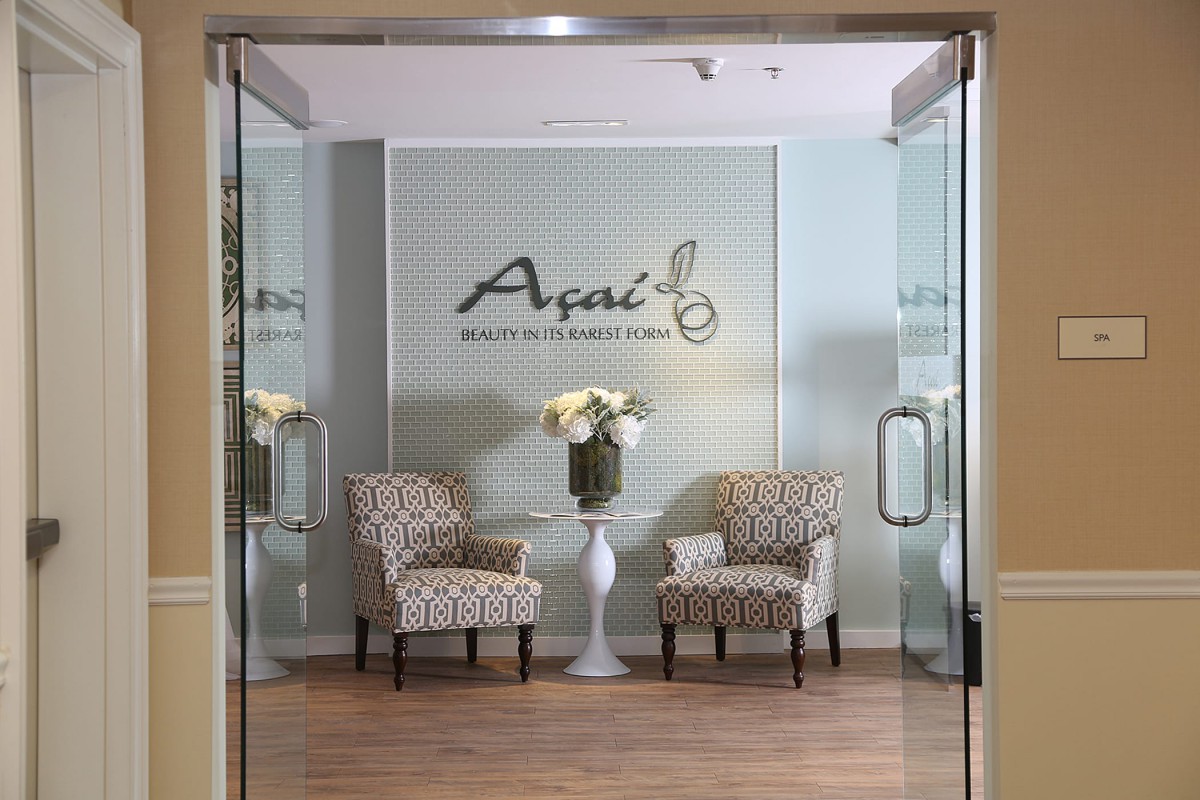 A modern waiting area with two patterned chairs and a floral arrangement.