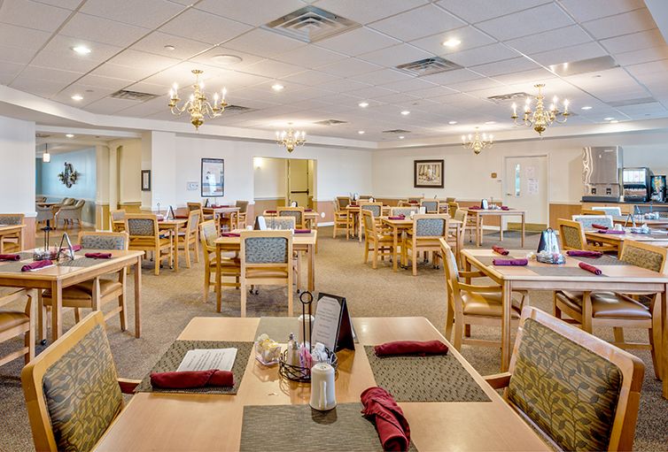 An interior view of a spacious restaurant dining area with neatly arranged tables and chairs.
