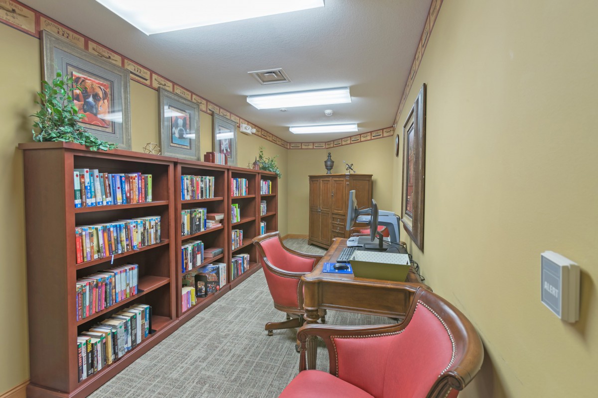A cozy library with bookshelves and comfortable chairs for reading.