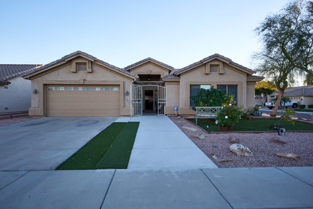 A single-story suburban house with a garage and landscaped front yard.