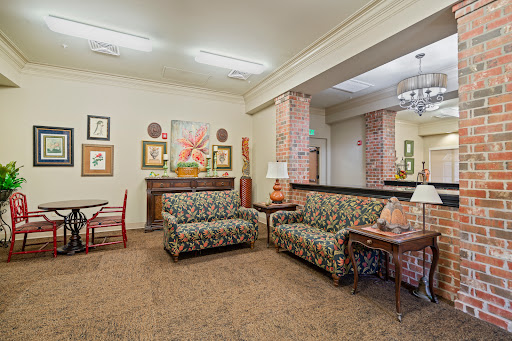 A cozy living room featuring patterned sofas and decorative artwork.