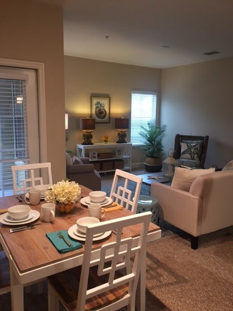 A cozy dining and living area with stylish furniture and a warm color palette.