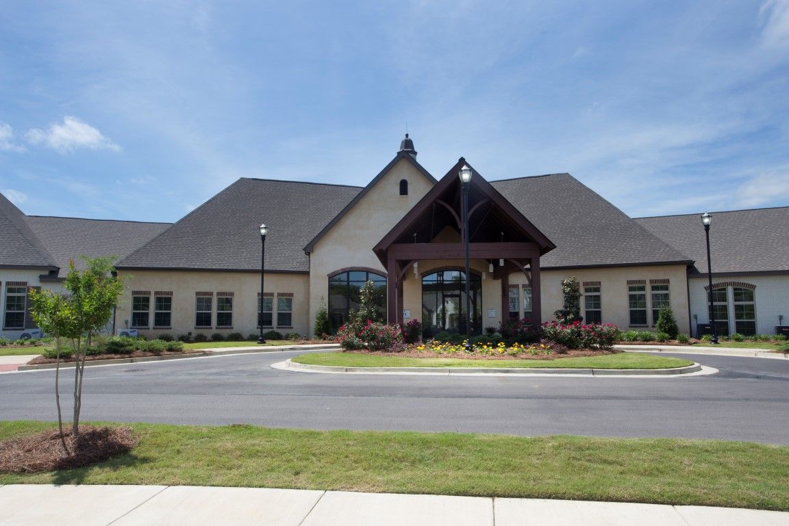 A suburban residential building with a prominent entrance and well-maintained landscaping.
