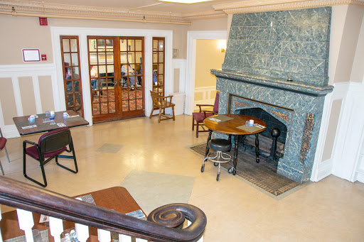 A cozy lobby area featuring a stone fireplace and inviting seating arrangements.