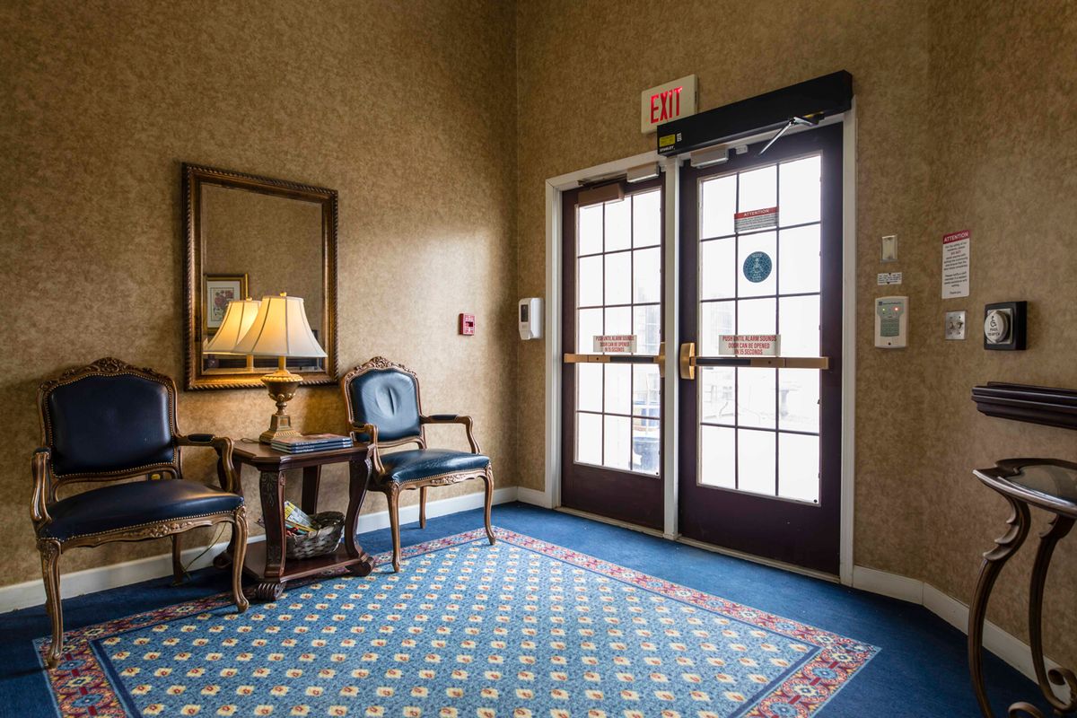 A cozy hotel lobby with elegant furniture and a patterned carpet.