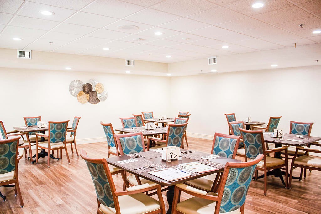 An elegant dining area with neatly arranged tables and chairs.
