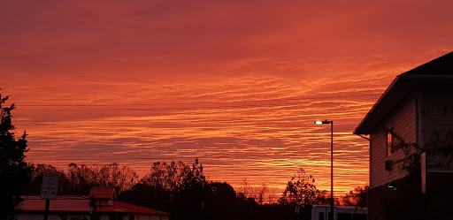 A stunning sunset paints the sky in vibrant shades of orange and pink, creating a serene atmosphere.