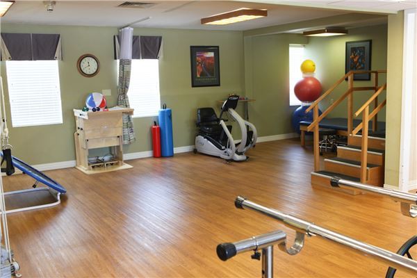 A physical therapy room with exercise equipment and gym facilities.