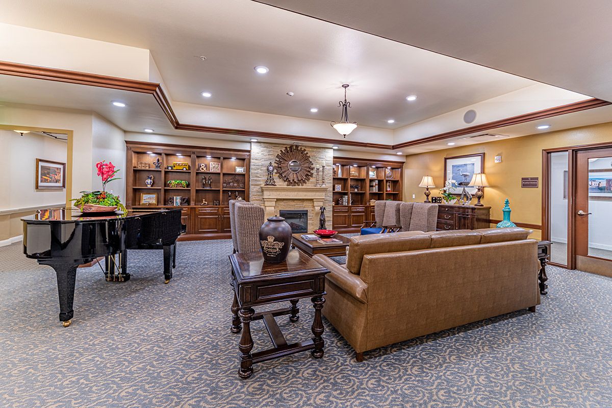 A cozy living room with a fireplace, bookshelves, and comfortable seating.