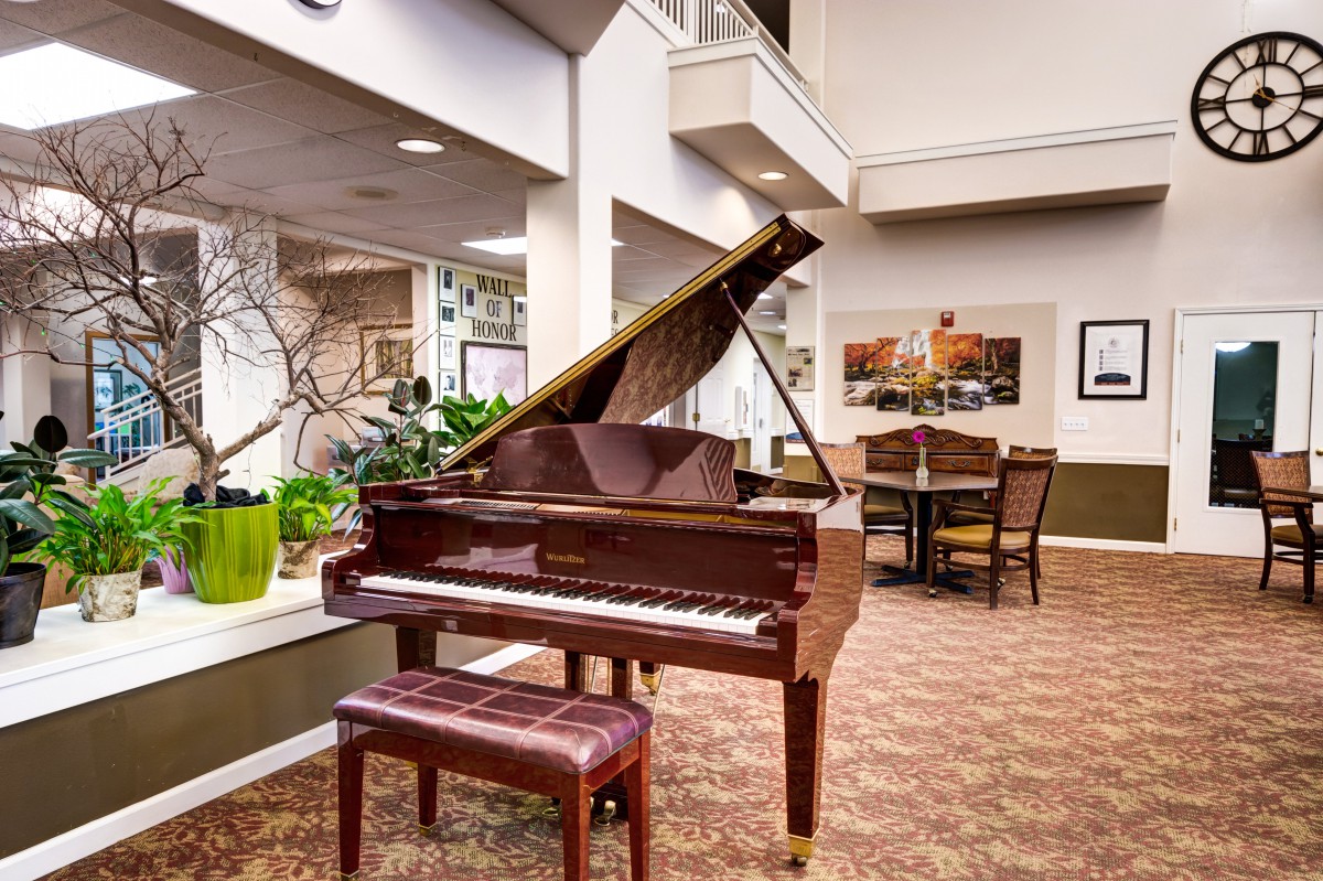 A cozy interior featuring a grand piano and seating area.