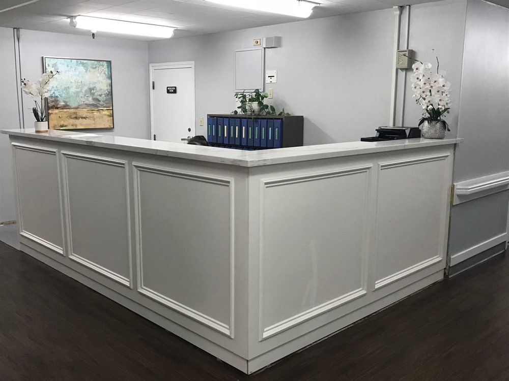 A modern reception desk in a well-lit office interior.