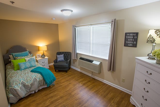 A cozy and modern bedroom with stylish furnishings and natural light.