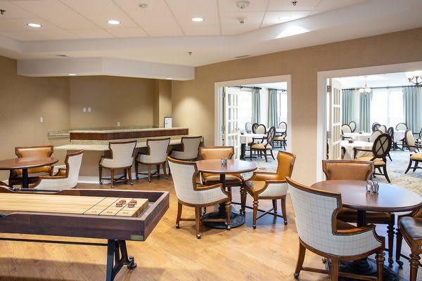 A cozy lounge area with tables and chairs arranged for relaxation.