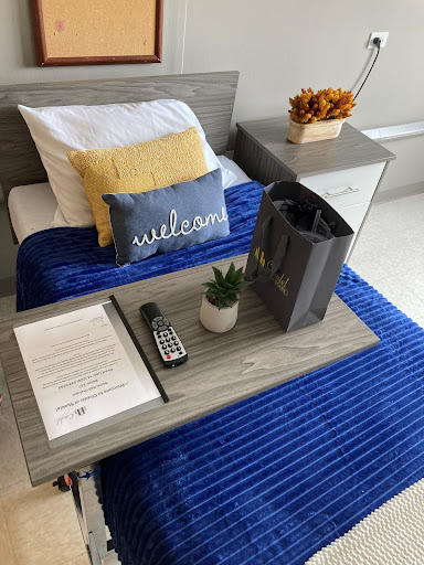 A welcoming and cozy setup featuring a neatly made bed, decorative pillows, and thoughtful touches for comfort.