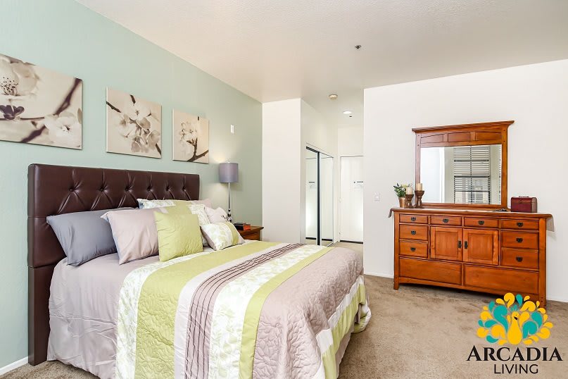 A cozy bedroom with a neatly made bed and stylish decor.