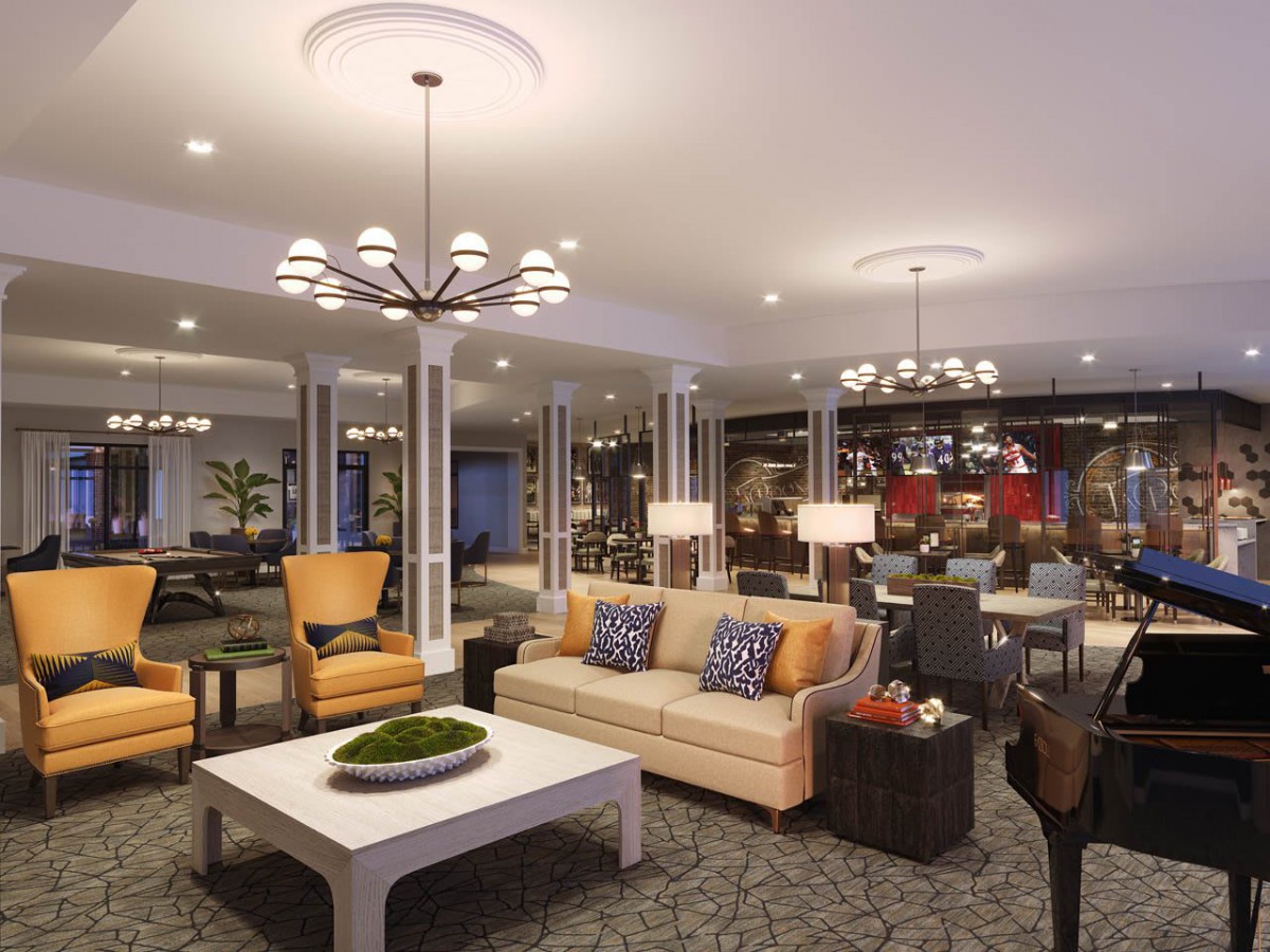 A spacious and elegantly designed living room featuring comfortable seating and modern lighting.