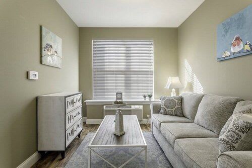 A modern, minimalist living room with a comfortable sofa and stylish decor.