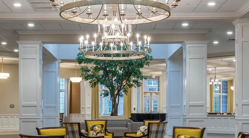 Elegant lobby with chandeliers and cozy seating area.