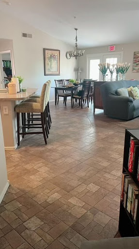 A cozy open-concept living and dining area featuring stylish furniture and elegant flooring.
