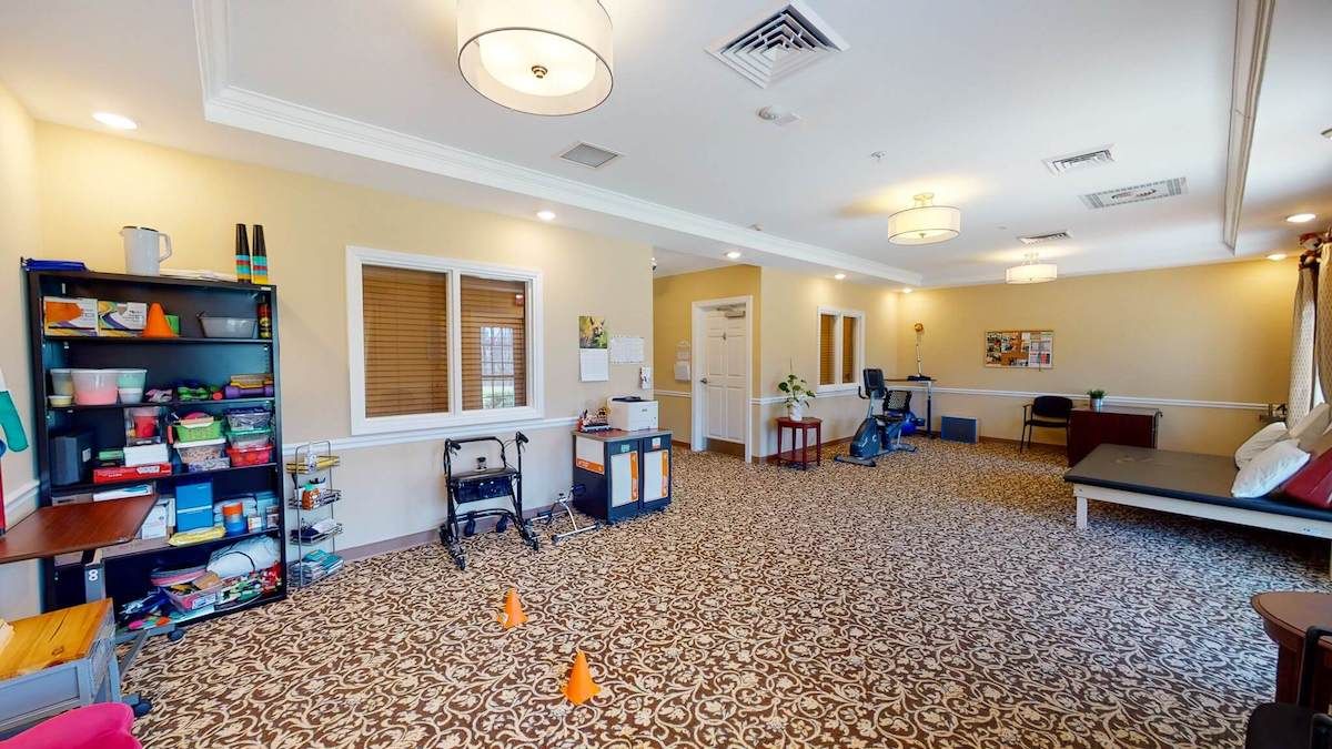 A spacious, carpeted lobby area with seating and lighting fixtures.
