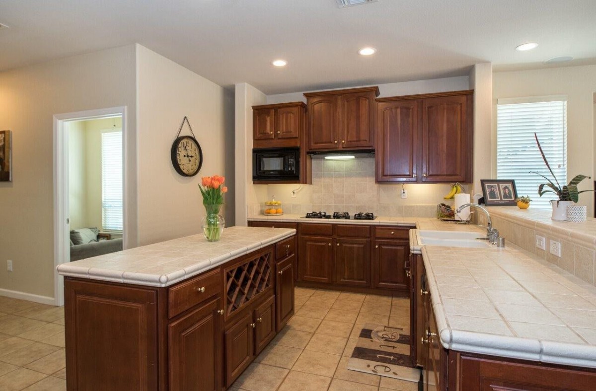 Modern kitchen with wooden cabinets and a spacious countertop.