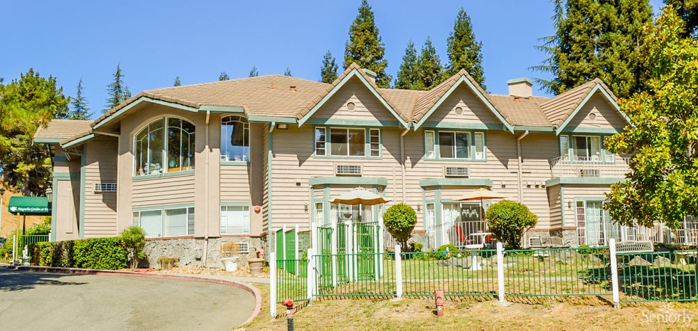 A suburban house with a well-maintained lawn and trees in the background.
