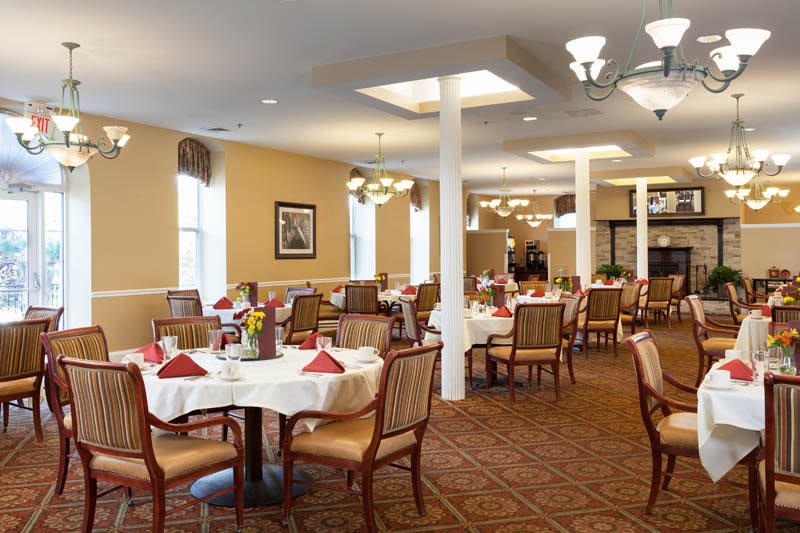 An elegantly decorated dining room with neatly arranged tables and comfortable seating.