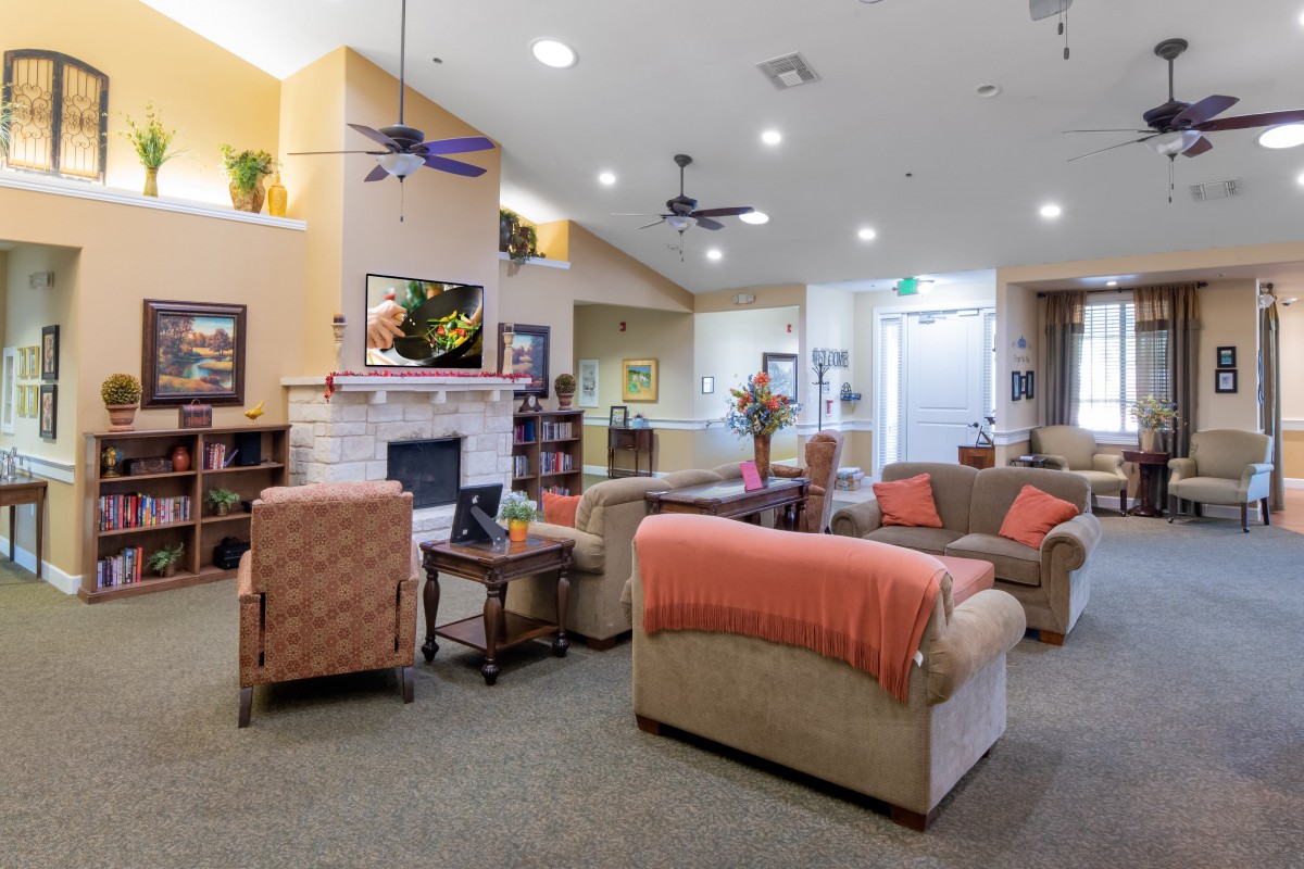 A cozy living room with comfortable couches, a fireplace, and warm lighting.