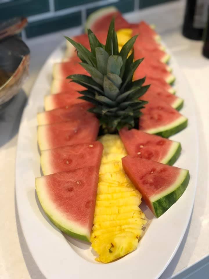 A beautifully arranged fruit platter featuring slices of watermelon and pineapple.
