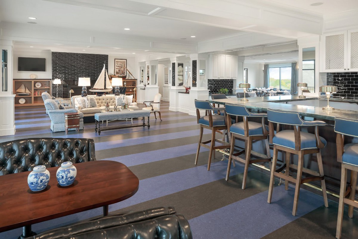 Modern open-concept living room featuring striped flooring and elegant bar seating.